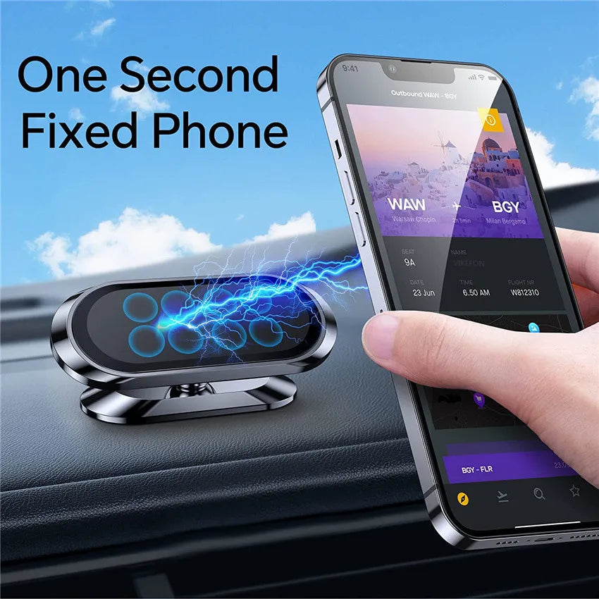 A hand holds an iPhone with a magnetic car phone holder placed on a dark car surface.