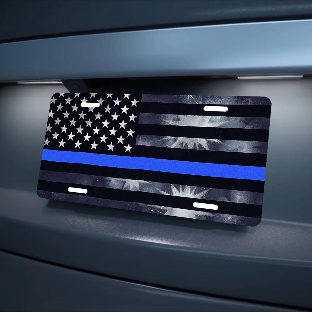 A decorative aluminum flag sign featuring the American flag design with a blue stripe and stars mounted on a dark gray surfac