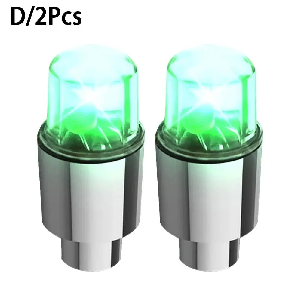 Two universal LED wheel lights for bikes and cars with silver bases and green illumination.