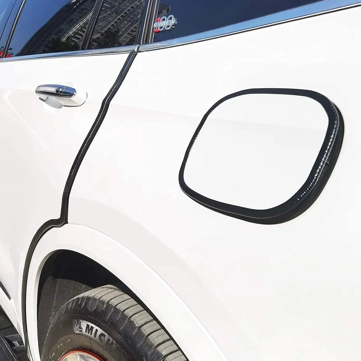 Close-up of a black rubber edge seal trim installed on the door frame of a white vehicle.