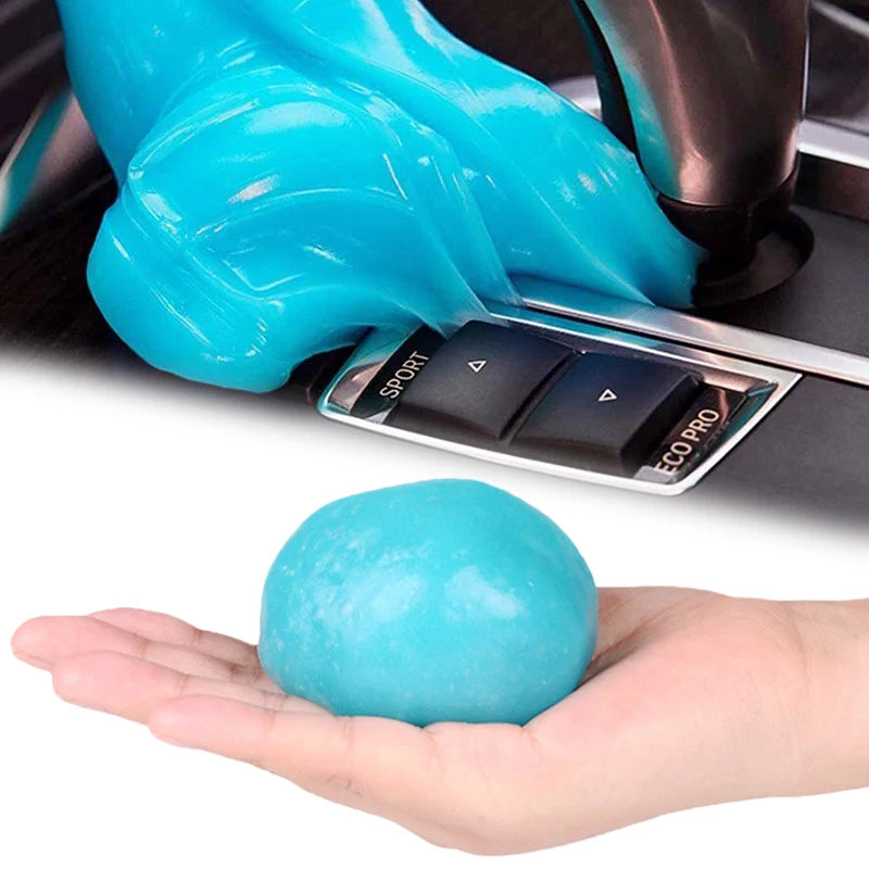 A hand holds a bright blue gel cleaner, which is being dispensed from a black applicator tool.