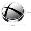 A round, silver suction cup rearview mirror with a black 'X' design.