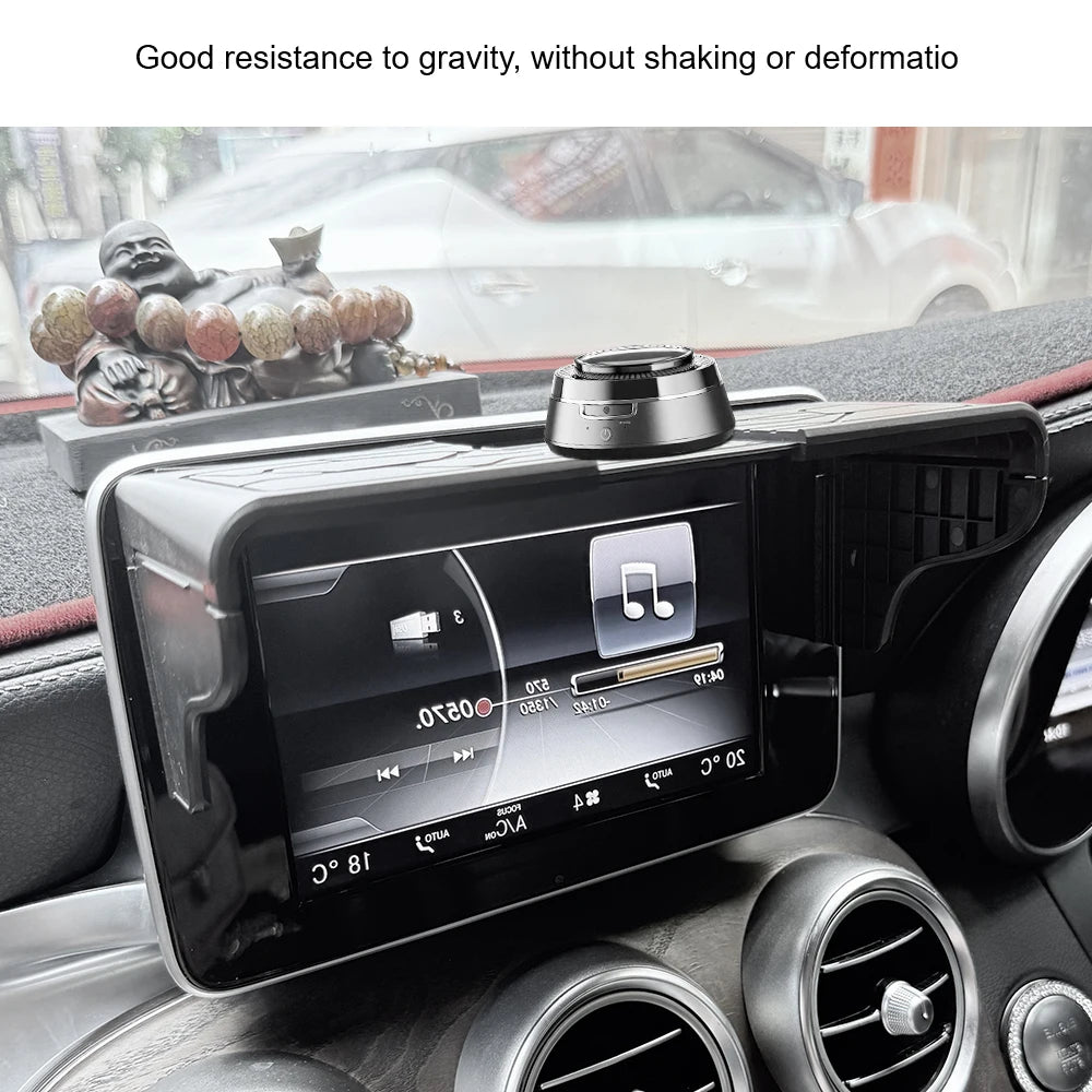 A black car GPS navigator is mounted on a dashboard, showing a display and an adjustable visor.