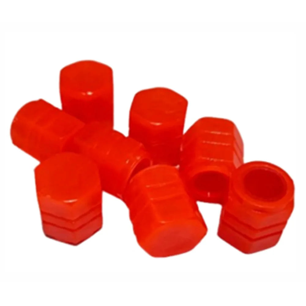 A collection of bright red, cylindrical tire valve caps.