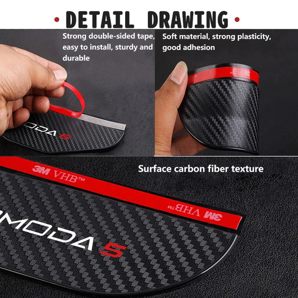 Close-up view of a black carbon fiber rearview mirror rain guard with a red accent, showing its texture and installation feat
