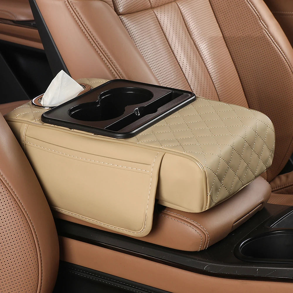A beige car armrest cushion with a tissue holder is placed on a brown leather seat.