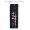 A long silver chain featuring pink lotus-shaped pendants on a dark blue background.