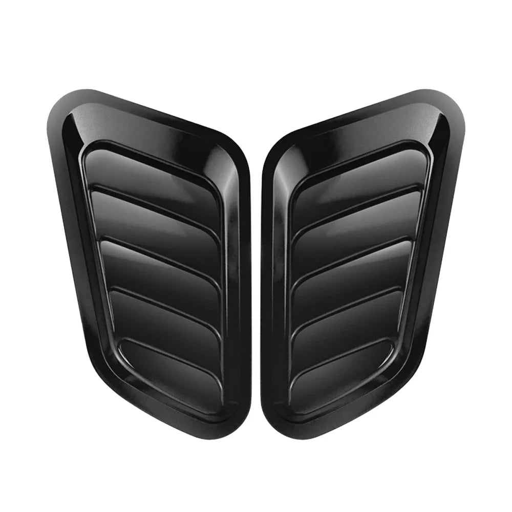 A pair of black decorative air intake vents for a car hood.