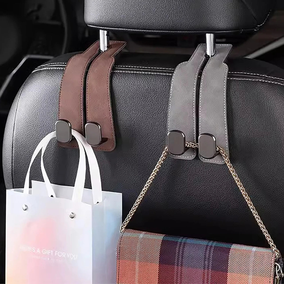 Black leather car seat headrest hooks with brown and gray leather straps for vehicle organization