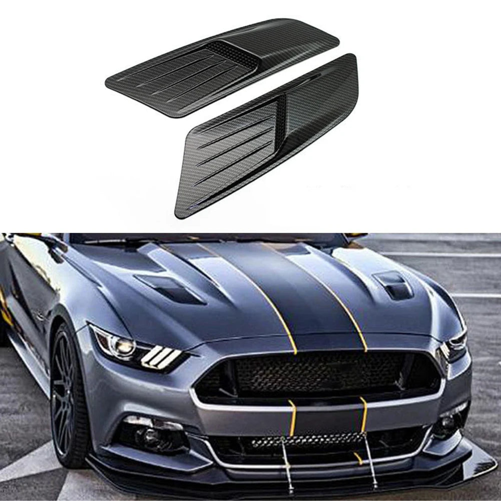 A black retrofit false air outlet hood installed on a Ford Mustang.
