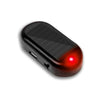 A black solar powered anti-theft car warning light with a red lens.