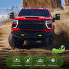A red Ford F-150 truck with silicone tow hitch covers installed in a desert environment.
