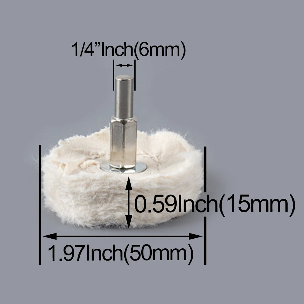 A silver 1/4 inch polishing wheel with a cylindrical shaft is shown resting on a white, fibrous material.