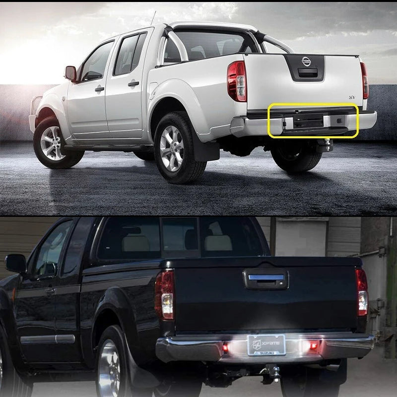 A white Nissan Frontier pickup truck with aftermarket LED license plate lights installed on the tailgate.