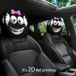 Two black plush headrest covers with white hair and pink bows are shown inside a car.