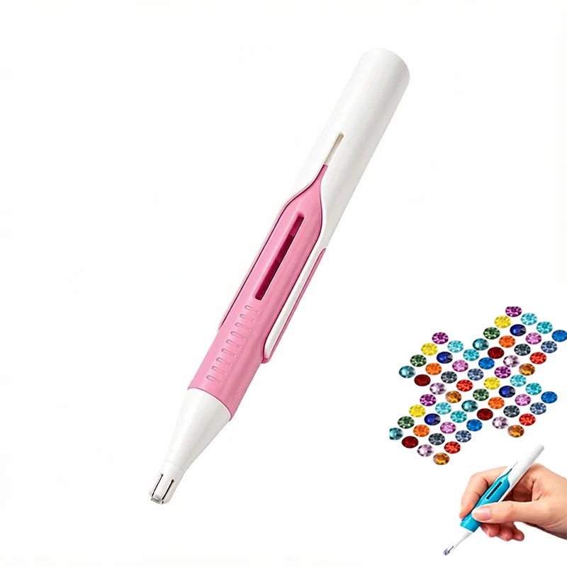A pink and white precision diamond painting bead dispenser pen with a fine tip is shown being held by a hand.