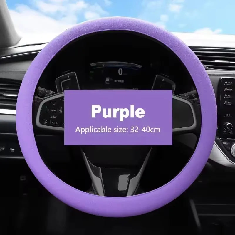 Purple universal silicone steering wheel cover installed in a car interior.