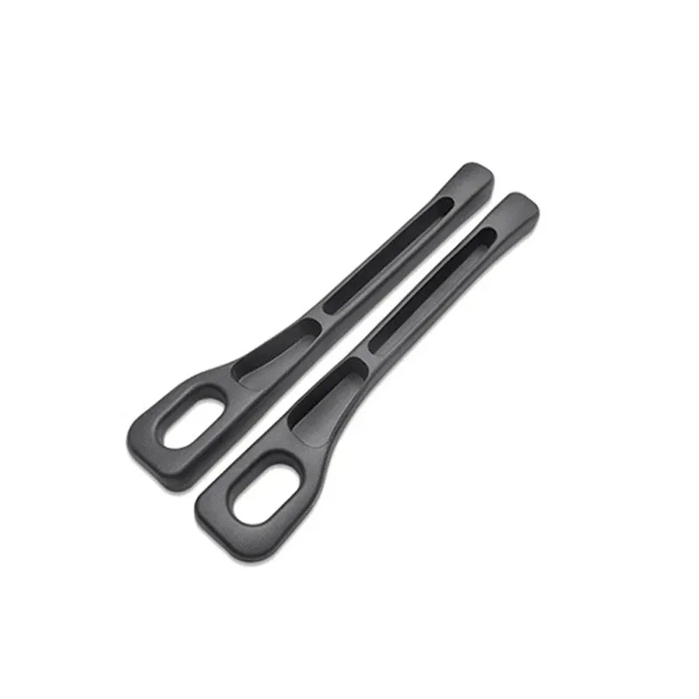 A pair of black car seat gap filler organizers with elongated, curved grips.