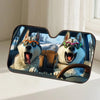 A pair of dog-themed car windshield sunshades featuring two dogs wearing sunglasses sitting on a car seat.