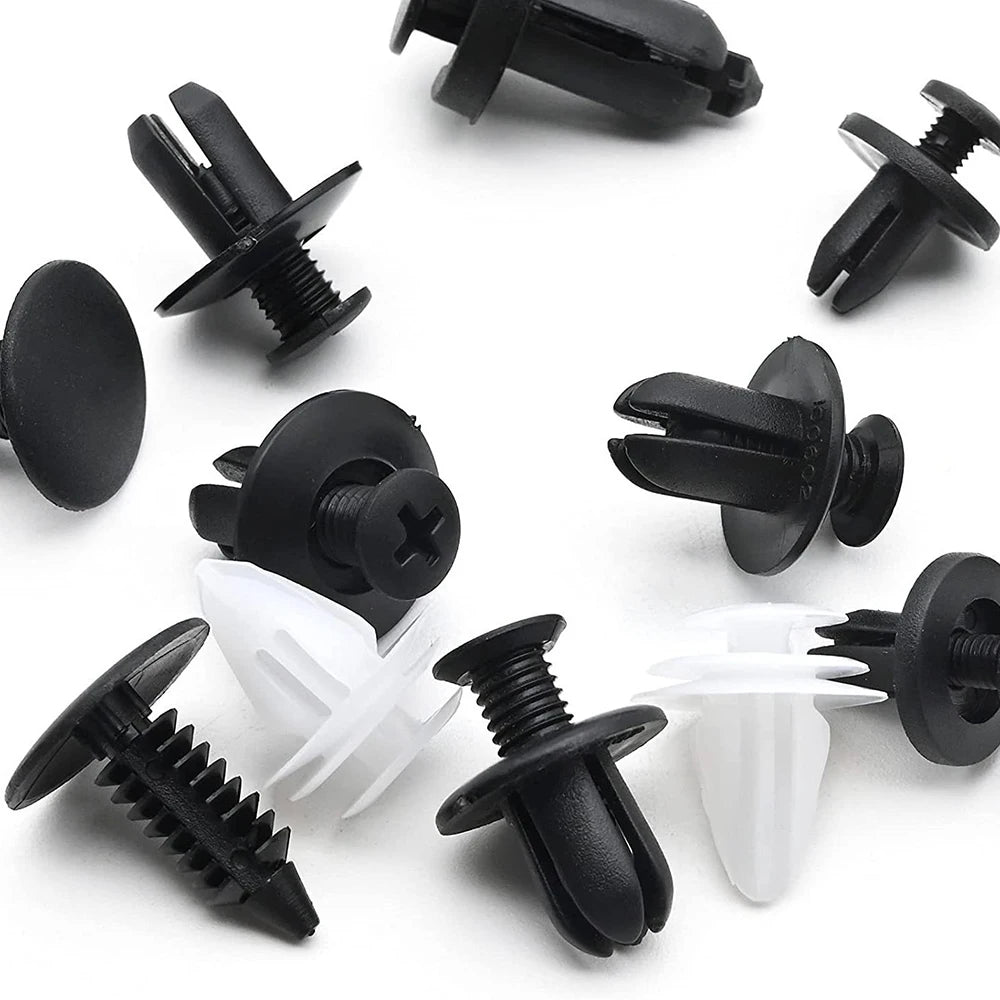 A collection of black and white universal auto fastener clips for car body trim.