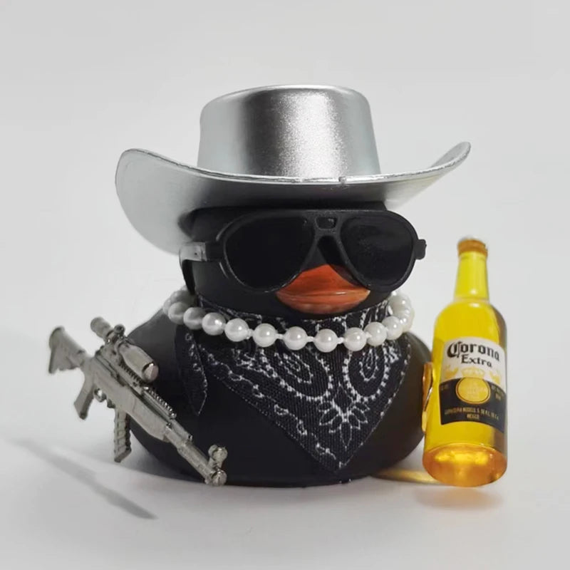 A black rubber duck ornament wearing a silver cowboy hat and sunglasses sits next to a bottle of Corona Extra.