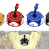 Four colored CNC machined fuel tank caps for Suzuki motorcycles displayed individually.