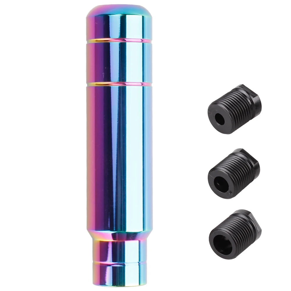A long, cylindrical aluminum gear shift knob with a iridescent blue and pink finish.