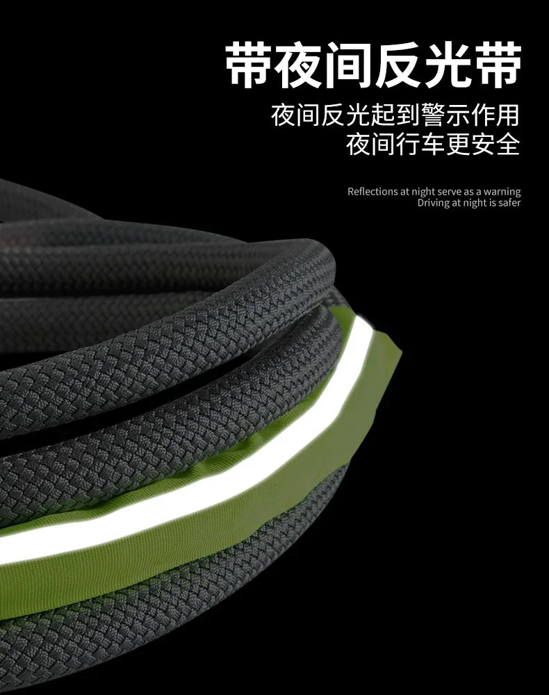 Close-up of a thick, textured green towing rope with bright white reflective strips against a black background.