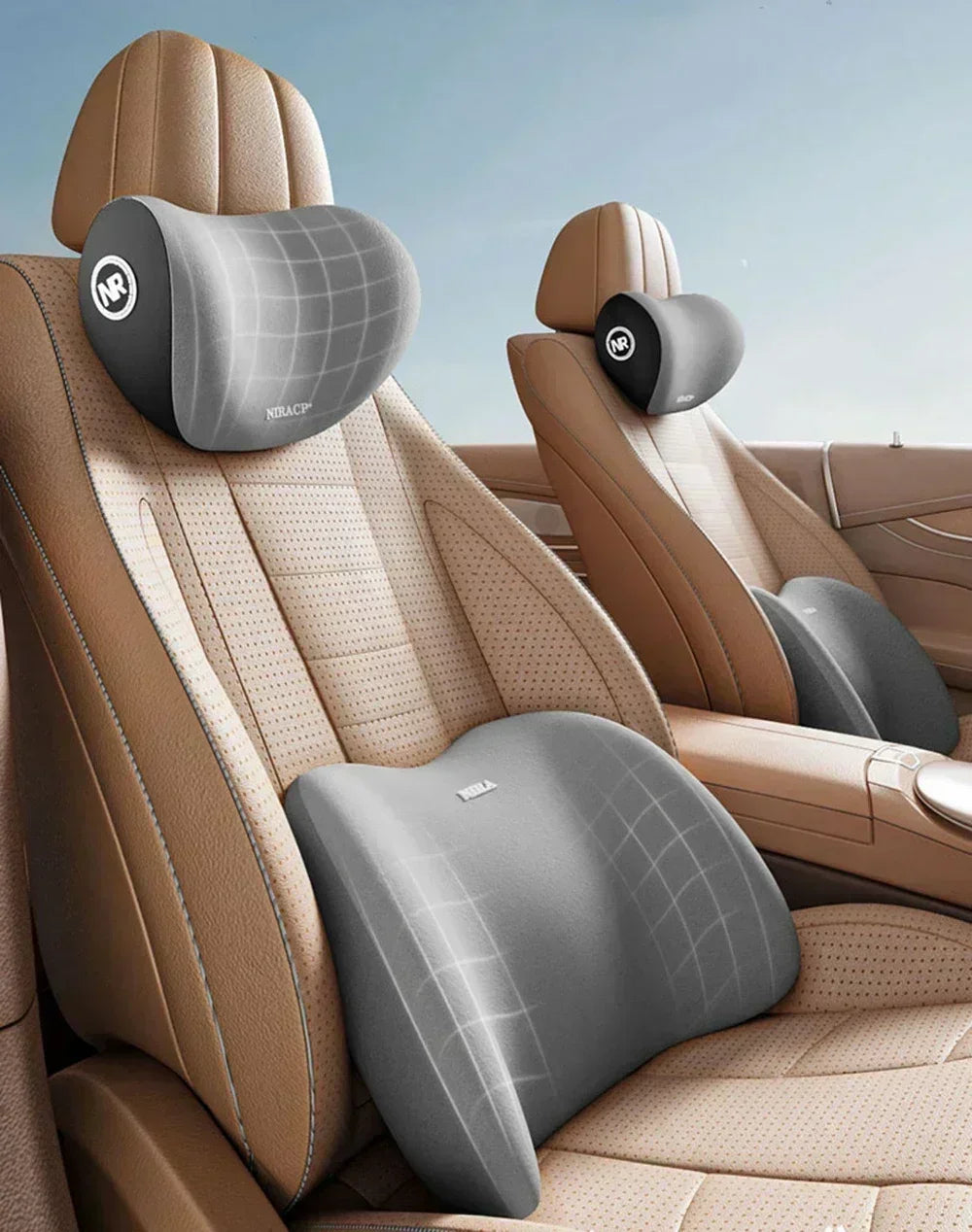 A beige ergonomic memory foam neck and lumbar pillow set shown in a car seat interior.