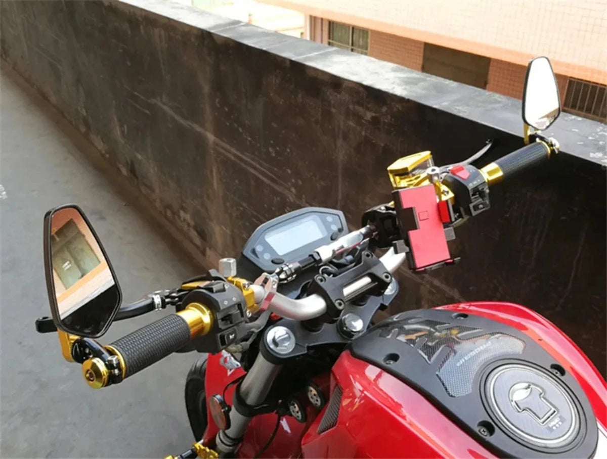 A close-up view of a red motorcycle with universal rearview mirrors mounted on the handlebars.