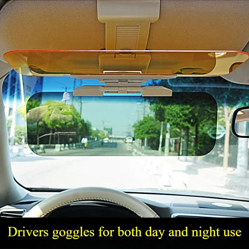 A driver's view through a car window showing a sun visor and the exterior road.