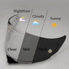 A motorcycle helmet visor demonstrating light conditions from clear to dark, labeled with nighttime and weather types.