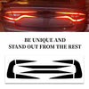 A close-up of a red Dodge Charger's taillight with a black decal applied.