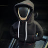 A black Gear Shift Hoodie cover with a hood and drawstring is shown inside a car console.