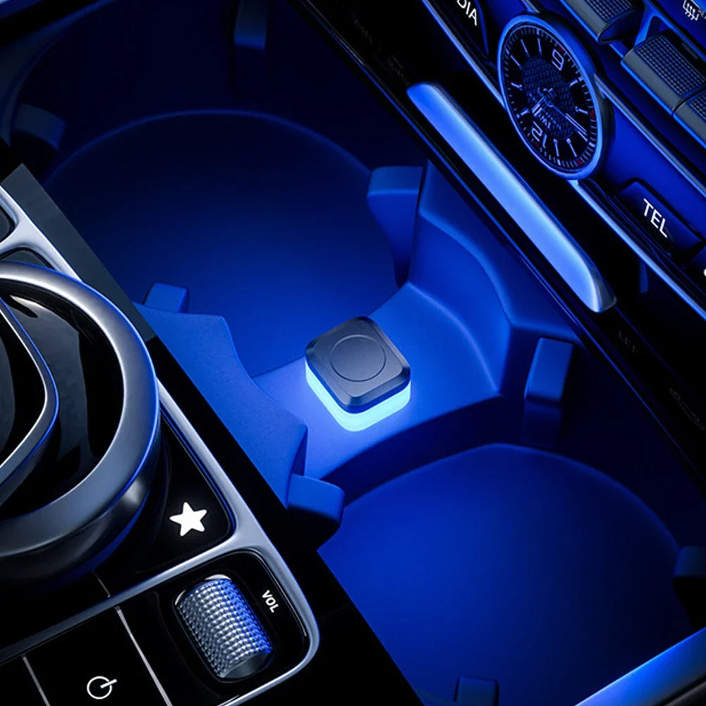 Close-up view of a car interior featuring blue ambient LED lights and control buttons.