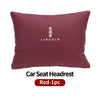 A maroon Lincoln car seat headrest neck support pillow with a perforated texture.