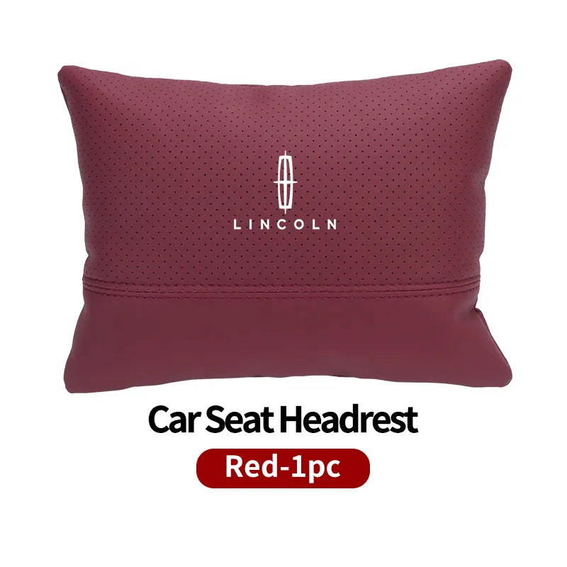 A maroon Lincoln car seat headrest neck support pillow with a perforated texture.