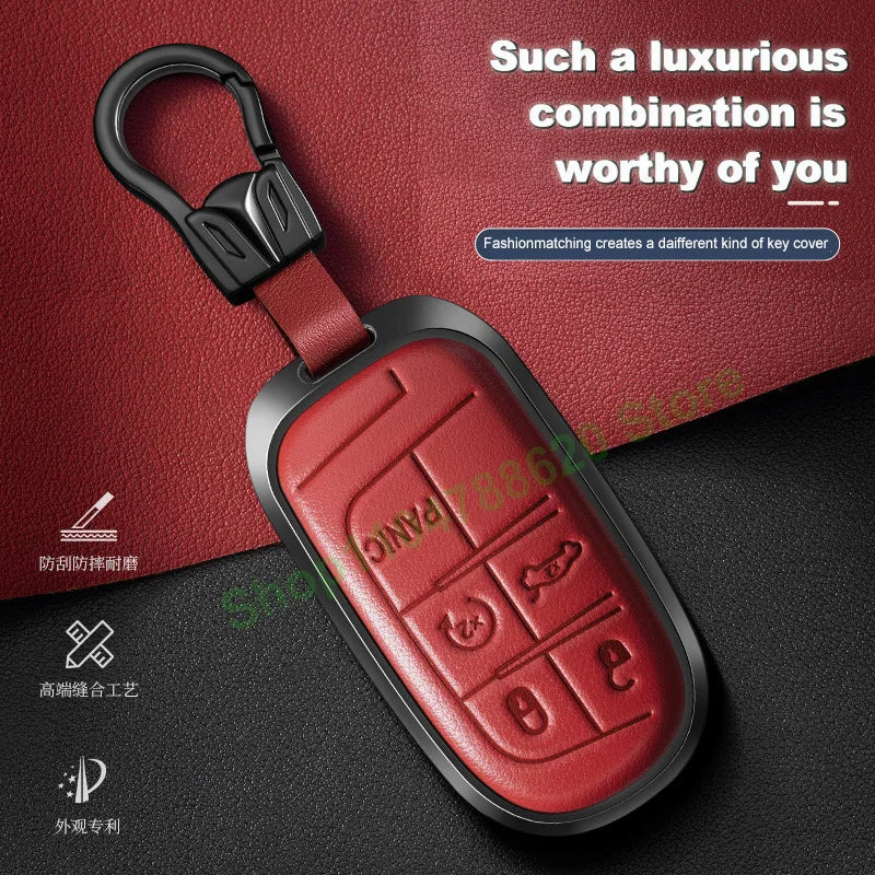 A red leather car key fob cover with a black metal clasp and various key cutouts shown against a dark background.