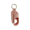 A pink leather portable inhaler storage case with a metal keychain ring.