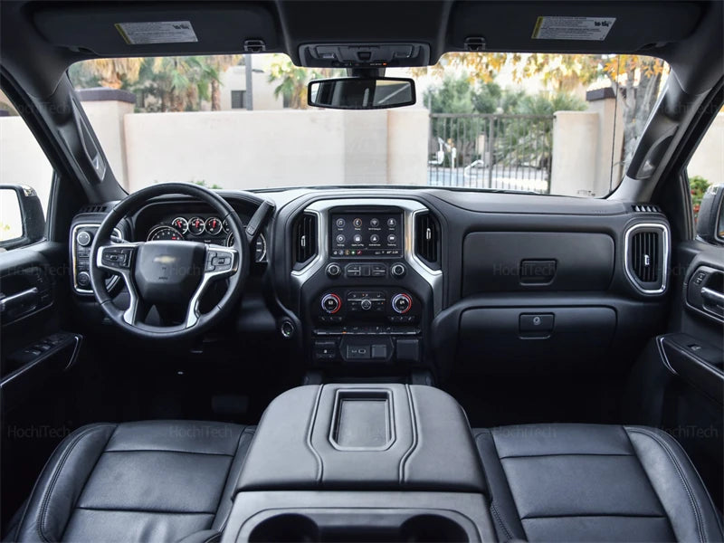 Interior view of a truck dashboard showing a custom dashboard mat installed on the center console.
