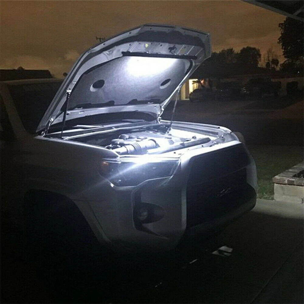 Under hood LED work light with automatic on/off switch shown open on a vehicle hood at night