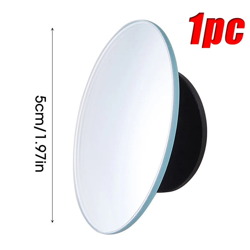 A circular, rotating blind spot mirror with a white reflective surface and a black base.