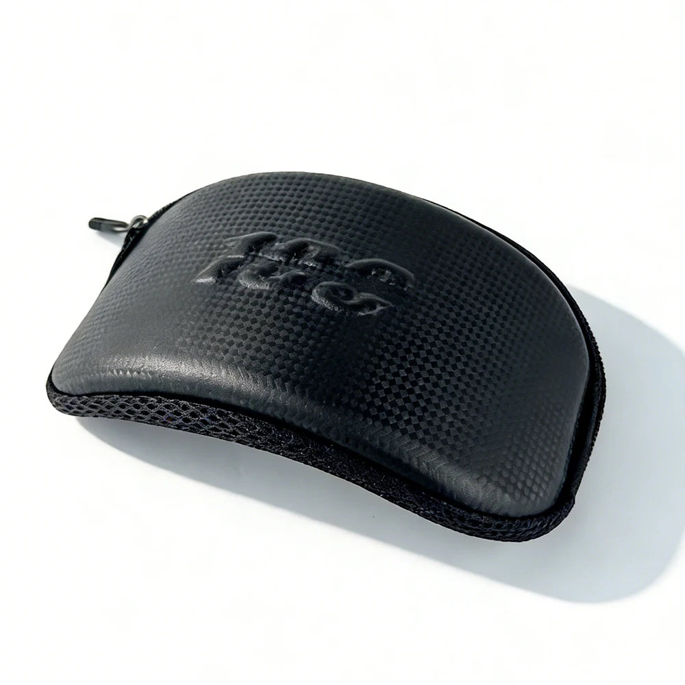 Black windproof sports goggles with UV protection resting on a white surface.