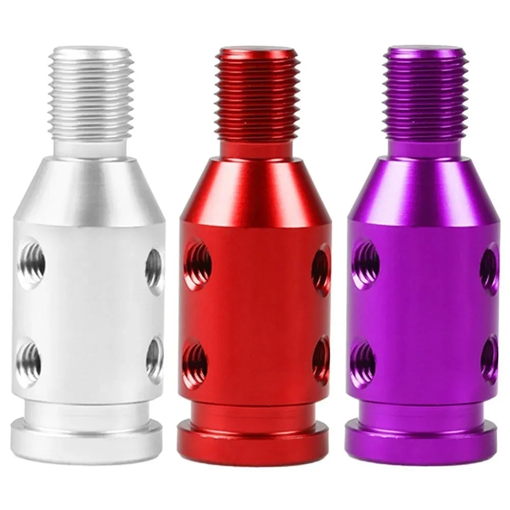 Three universal gear shift knob adapters in silver, red, and purple finishes.