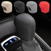 A black gear shift knob cover is shown with various color options, including beige, gray, and red.
