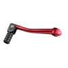 A close-up view of a red universal motorcycle gear shift lever.