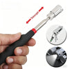 A hand holds a telescoping magnetic pickup tool with an LED light, showing the tool and its components.