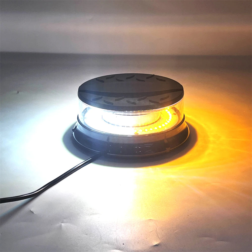 An emergency LED strobe light illuminates a surface, showing bright white light and an orange glow.