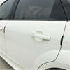 Close-up of a white car door featuring an installed anti-scratch guard trim strip.