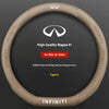 A close-up view of a beige steering wheel cover for an Infiniti vehicle, featuring the Infiniti logo and text.